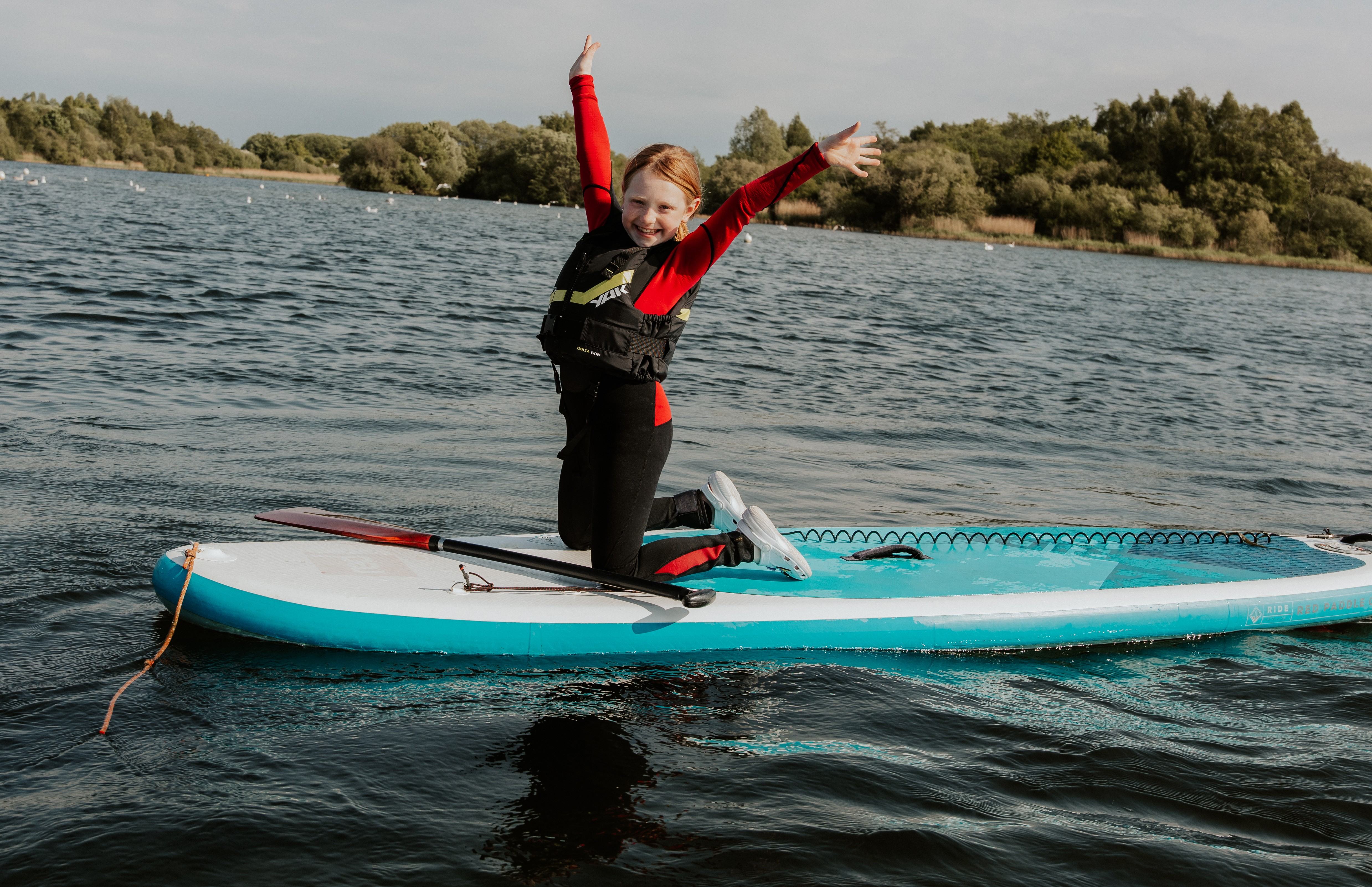 A girl paddleboarding at Scotman's Flash